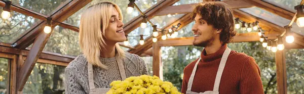 In a bright greenhouse filled with vibrant flowers, Young loving gay couple share a joyful moment. — Stock Photo