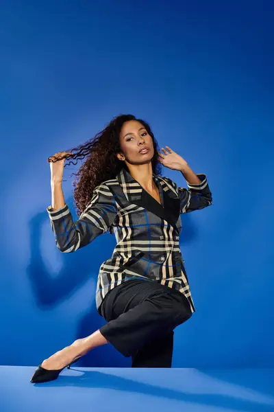 Woman confidently poses with hair flowing, showcasing her unique style in a creative setting. — Stock Photo