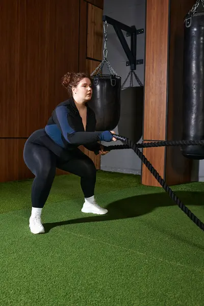 Engaging in a powerful exercise routine while using battle ropes for strength training. — Stock Photo