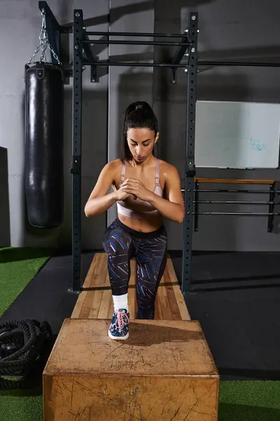 A dedicated woman demonstrates strength with box step ups during their workout. — Stock Photo