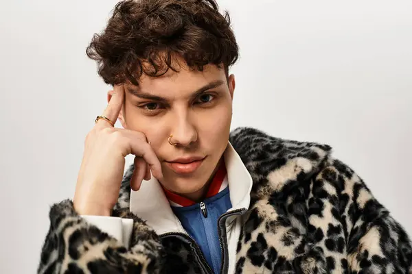 Handsome man poses thoughtfully, showcasing confidence and unique style in a modern space. — Stock Photo