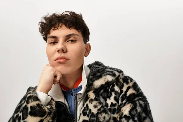 Man showcases a bold fashion choice, blending textures and patterns with a striking look. — Stock Photo