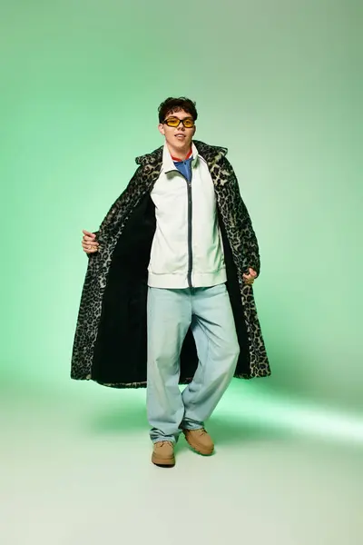 Handsome individual presents a bold outfit with flair in an artistically lit environment. — Stock Photo