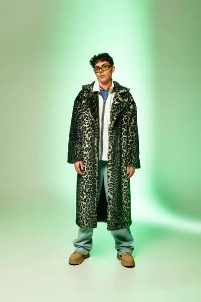 Handsome man confidently poses in a bold leopard print coat and trendy attire, exuding charisma. — Stock Photo
