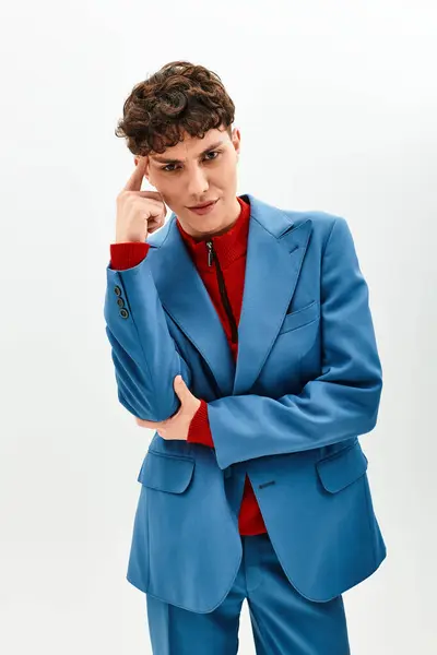 Handsome man showcases modern fashion in a chic blue suit with a red sweater underneath. — Stock Photo