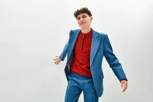 Handsome individual showcases bold fashion in stylish attire against a clean backdrop. — Stock Photo