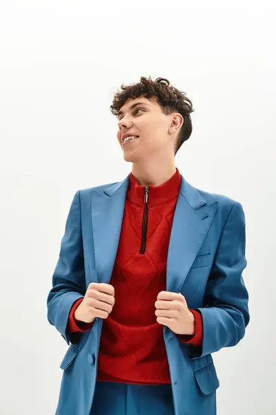 A fashionable man showcases his trendy style while posing in a bright studio space. — Stock Photo
