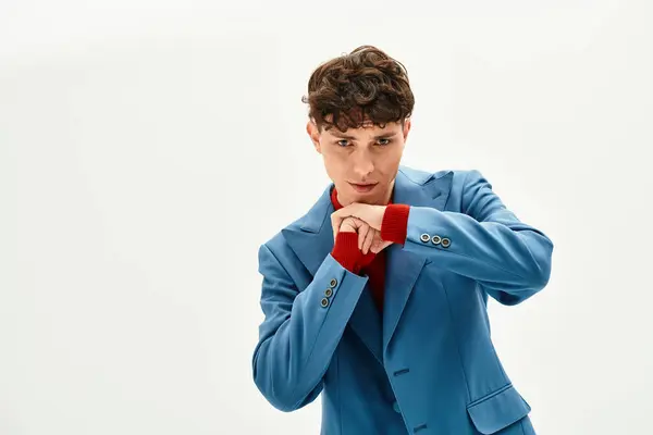 Handsome man showcases confidence and unique style in a modern outfit at the studio. — Stock Photo