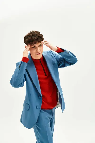 A stylish man poses elegantly, showcasing vibrant colors and trendy attire. — Stock Photo