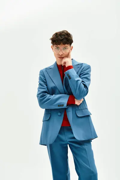 A dapper man showcases modern fashion with his bold blue suit and thoughtful expression. — Stock Photo