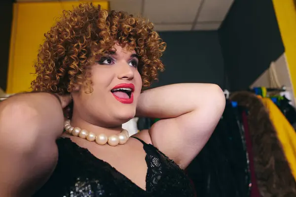In un vivace camerino, una drag queen si prepara per uno spettacolo natalizio, in mostra la loro arte. — Foto stock