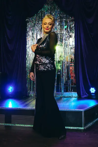 Vibrant drag queen shows eccentric flair with striking makeup and a stunning outfit on stage. — Stock Photo