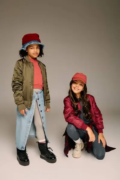 Two joyful girls showcase their stylish Christmas outfits in a cheerful celebration. — Stock Photo