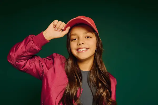 A happy little one is showcasing holiday cheer while wearing a stylish cap during Christmas. — Stock Photo