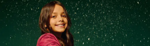 A little one shares a bright smile as festive snowflakes fall softly around her. — Stock Photo