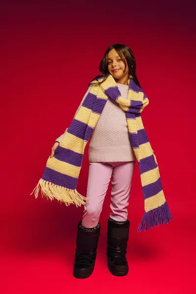 Girl dressed warmly in colorful scarf, excited for holiday festivities and winter fun ahead. — Stock Photo