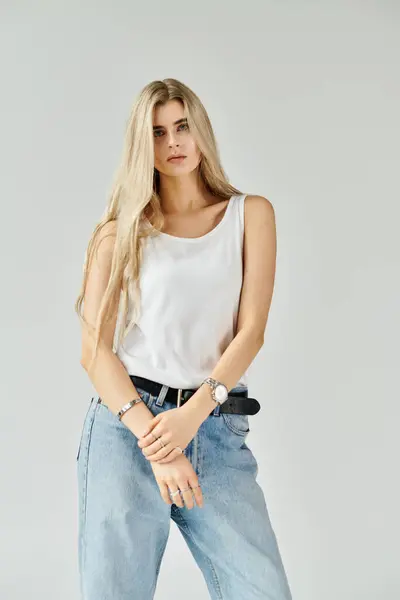 A stunning young woman with long blonde hair poses casually, highlighting her beauty. — Stock Photo