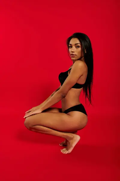 A stunning young Black woman poses gracefully in underwear, showcasing beauty and diversity. — Stock Photo