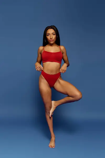 A confident young African American woman models stylish underwear in a studio setting. — Stock Photo