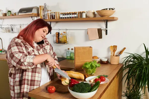 Young plus size woman cheerfully preparing fresh vegetables in a stylish kitchen setting. — Stock Photo