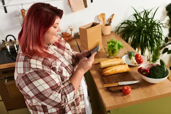 Cheerful woman enjoying cooking moment in bright kitchen filled with fresh ingredients — Stock Photo