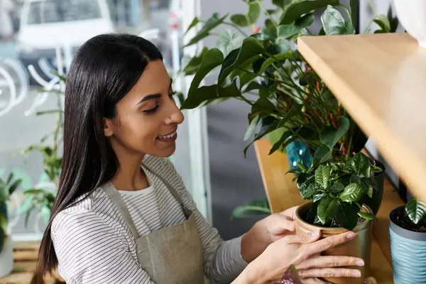 A talented florist organizes beautiful plants while managing her charming flower shop. — Stock Photo