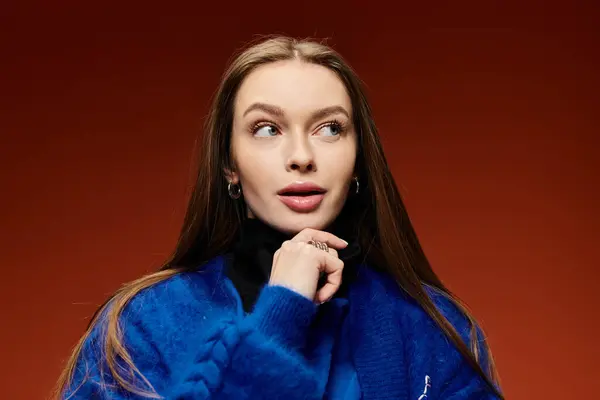 Woman with long hair in a bright outfit poses thoughtfully, highlighting her unique style. — Stock Photo