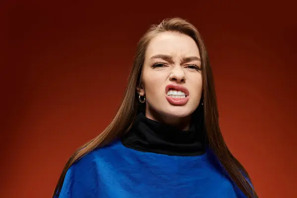 A vibrant stylish woman is showing her frustration in a creative studio environment. — Stock Photo