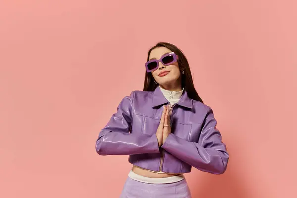 A stylish woman stands confidently in a prayer pose, flaunting her trendy outfit. — Stock Photo