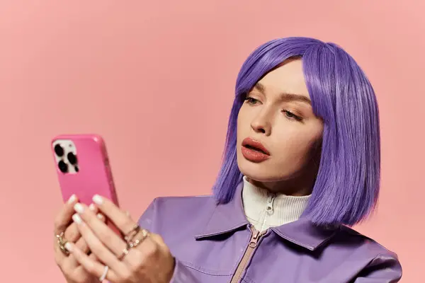 A vibrant woman with purple hair is focused on her smartphone in a colorful indoor space. — Stock Photo
