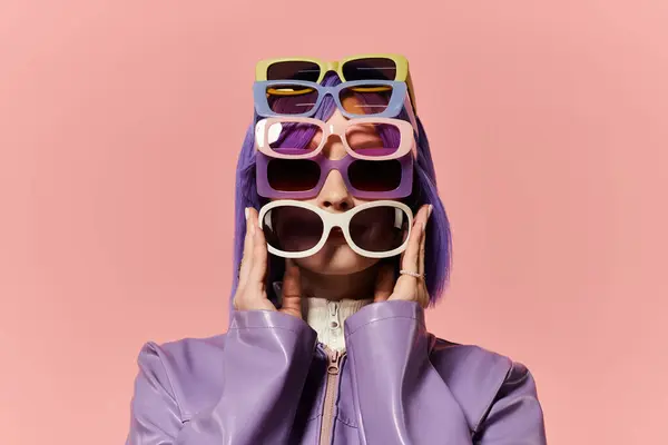 Beautiful woman poses with various colorful sunglasses, showcasing vibrant fashion choices. — Stock Photo