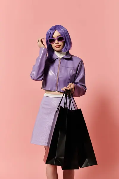 A fashionable woman showcases her vibrant style while holding shopping bags in a playful setting. — Stock Photo