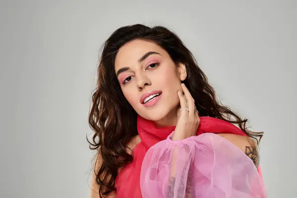 Young woman in vibrant clothing exudes beauty and confidence while posing softly. — Stock Photo