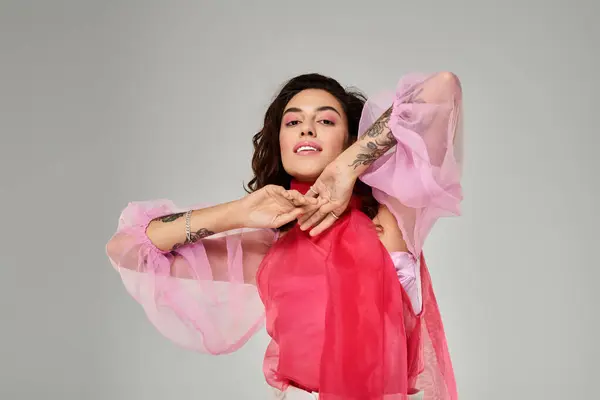 Young woman showcasing her vibrant outfit and playful attitude in a creative indoor setting. — Stock Photo