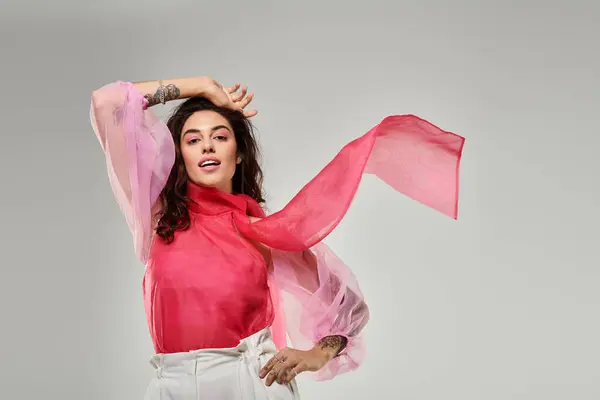 Young woman dressed in elegant attire showcases stylish scarf while striking a confident pose. — Stock Photo