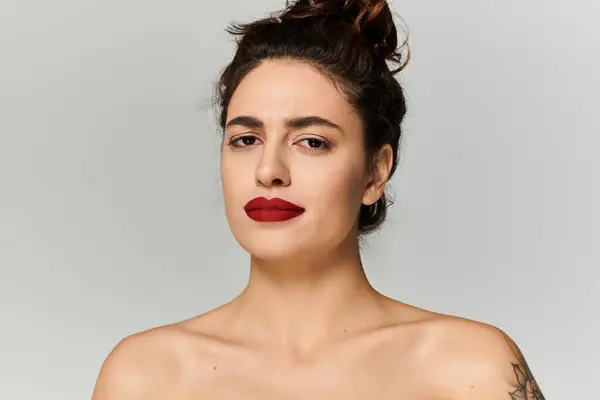 A young beautiful woman showcases her striking red lipstick and confident expression. — Stock Photo