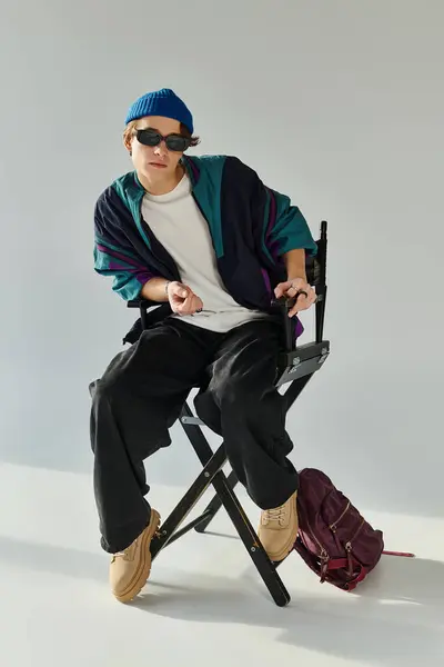 A stylish young student poses confidently in a studio, expressing youth culture and creativity. — Stock Photo