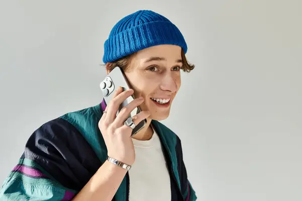 A young man exudes confidence, chatting lively in a stylish bomber jacket. — Stock Photo