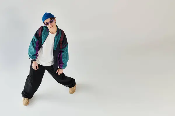 A fashionable young man poses in a bomber jacket while creating a laid-back vibe. — Stock Photo