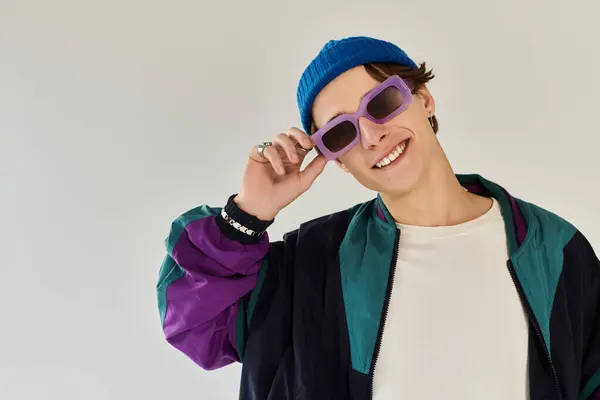 A stylish young man flaunts his unique look in a studio during his college years. — Stock Photo