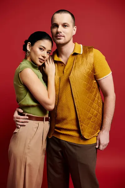 A beautiful young couple embraces in a studio, showcasing their love and stylish outfits. — Stock Photo