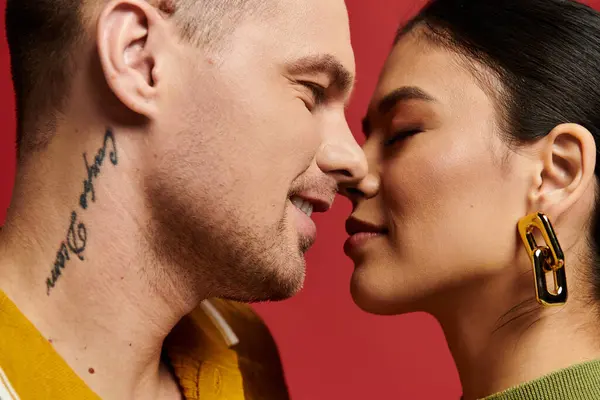 A charming young couple shares an intimate moment in a studio, showcasing their love for each other. — Stock Photo