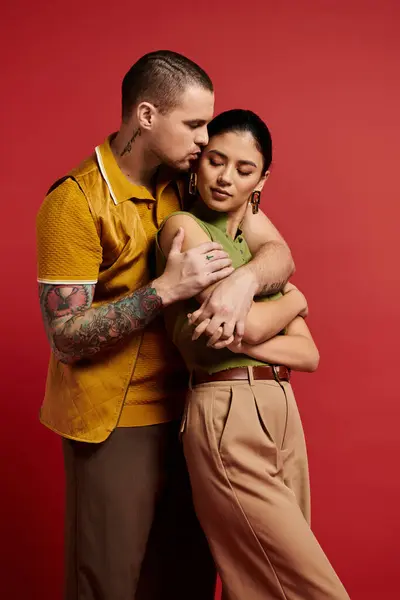 Young couple embraces in a stylish studio, showcasing love and fashion on Valentines Day. — Stock Photo