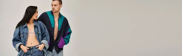 Young couple dressed in trendy outfits shares a special connection in a modern studio, banner — Stock Photo