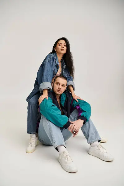 A stylish young couple shares a loving moment, embracing romance and connection. — Stock Photo
