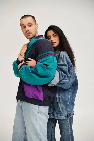 A young couple elegantly dressed enjoys a moment of romance in a studio setting together. — Stock Photo