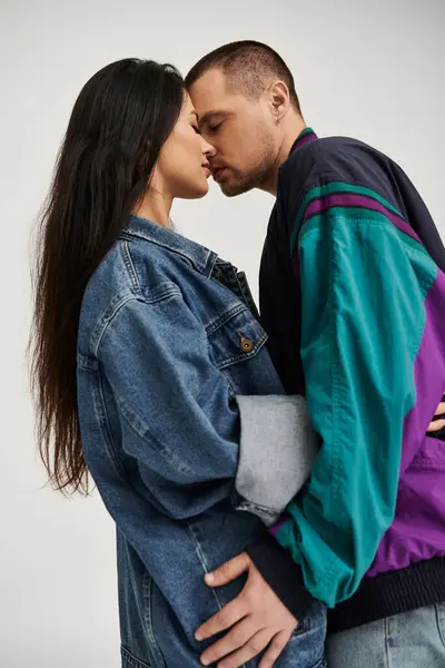 A beautiful young couple embraces closely, showcasing their love in a studio setting. — Stock Photo