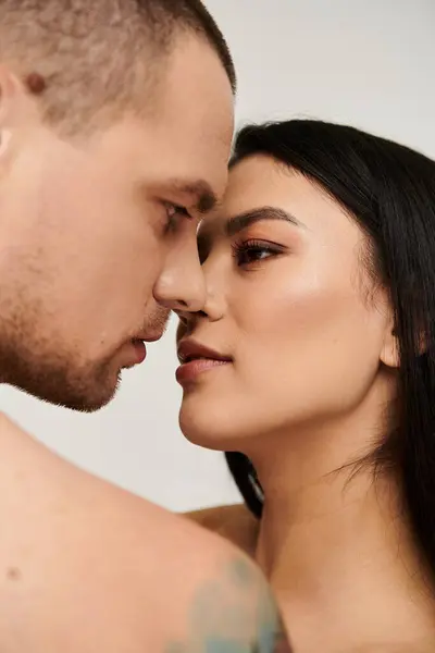 A young couple shares an intimate moment in a studio, celebrating love on Valentines Day. — Stock Photo
