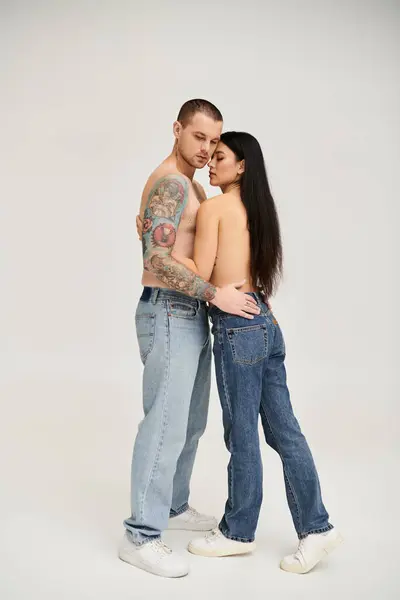 A young couple shares an intimate moment in a studio, celebrating love and desire. — Stock Photo