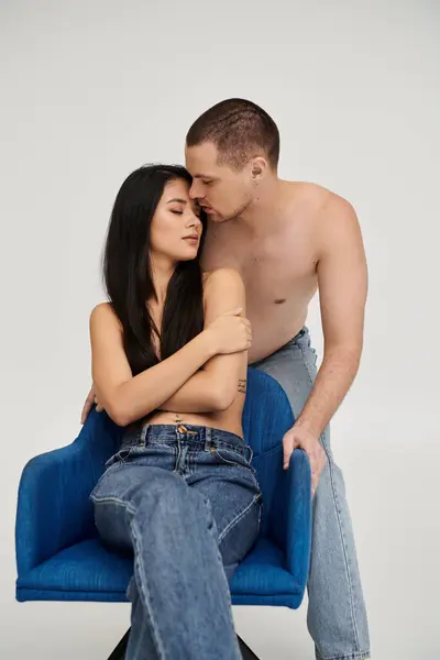 A seductive young couple shares an intimate moment, expressing deep love in a studio. — Stock Photo